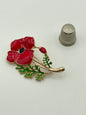 Broche de metal dorado y esmalte con forma de amapola