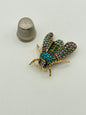 Broche de metal dorado y strass con forma de insecto