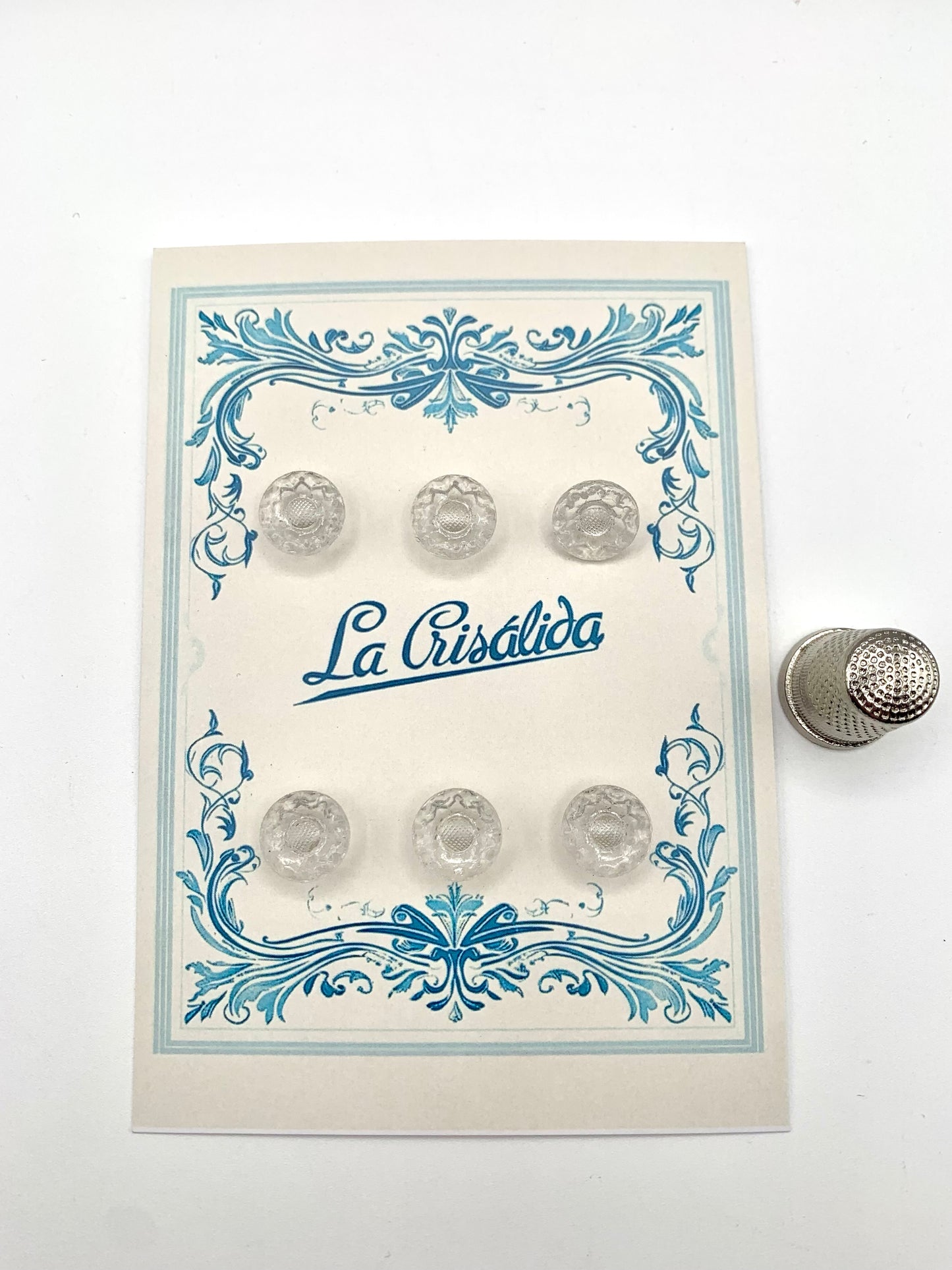 Cartón con 6 botones de vidrio con forma de flor, años 40, transparentes